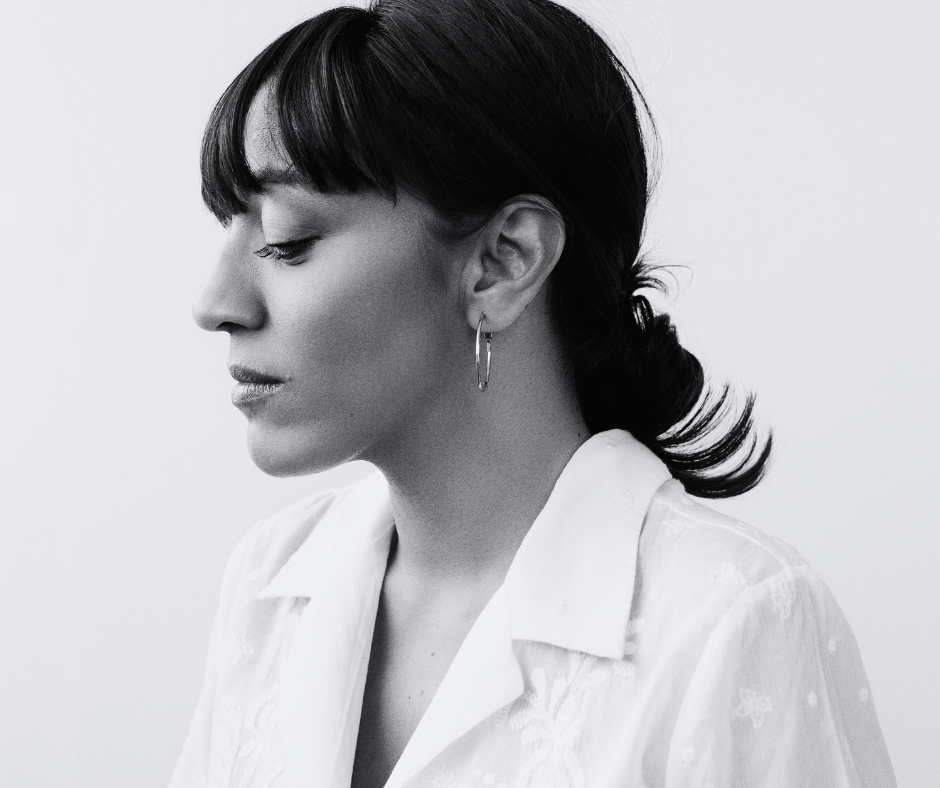 Woman in white shirt looking down